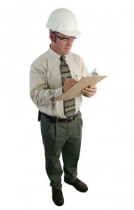 a construction safety inspector wearing a hard hat and safety goggles and reviewing a list - full view isolated