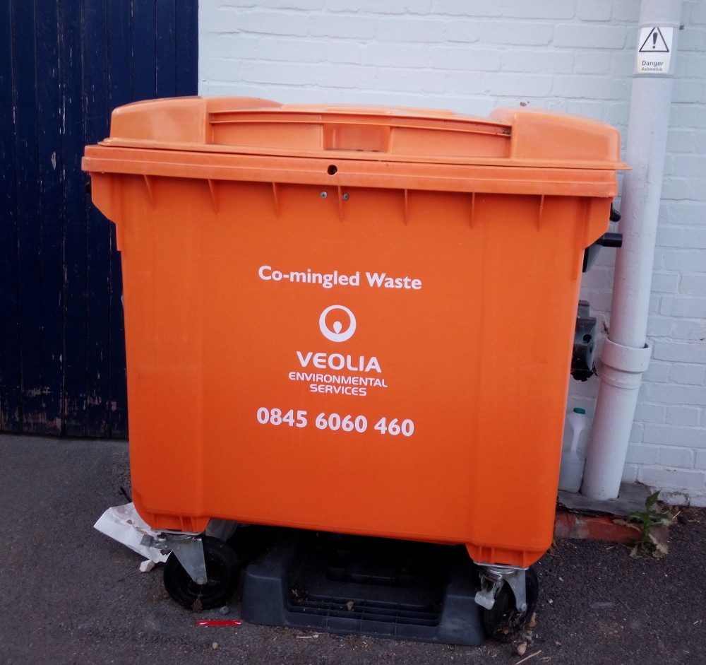 a large orange waste bin labelled Commingled Waste